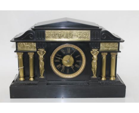 Large Victorian mantel clock with eight day spring-driven movement striking on a gong, gilt metal dial with black chapter rin