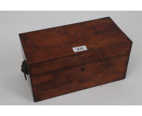 Early Victorian figured walnut tea caddy flanked by lion mask drop-handles, the interior with twin-lidded canisters flanking 