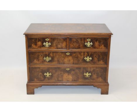Walnut chest of drawers, the well figured moulded top over two short and two long graduated drawers on bracket feet, 104cm wi