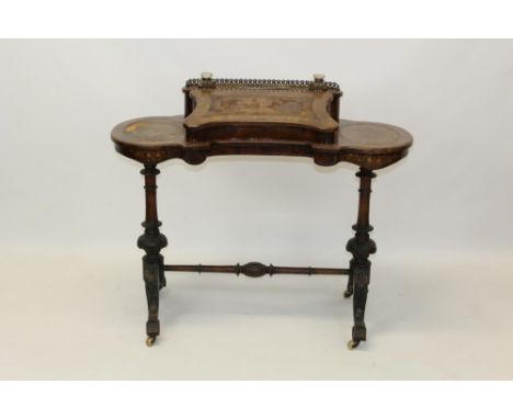 Victorian figured walnut and line-inlaid ladies' writing desk, the shaped top with rear brass gallery and leather inset slope