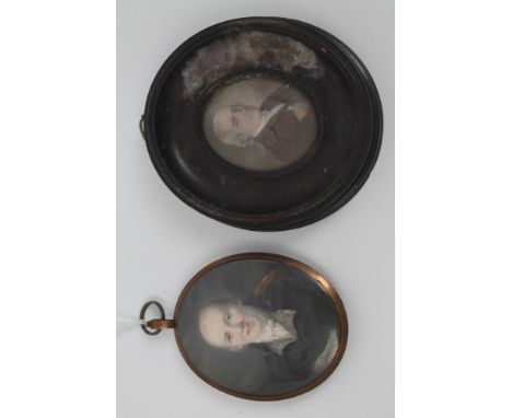 Early 19th century English School oval portrait miniature on ivory - a seated gentleman, in yellow metal frame with glazed ha