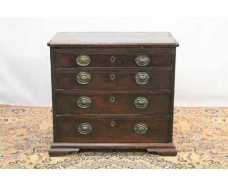 George II mahogany bachelors' chest, the top with re-entrant angles, having brushing slide over four graduated drawers on oge