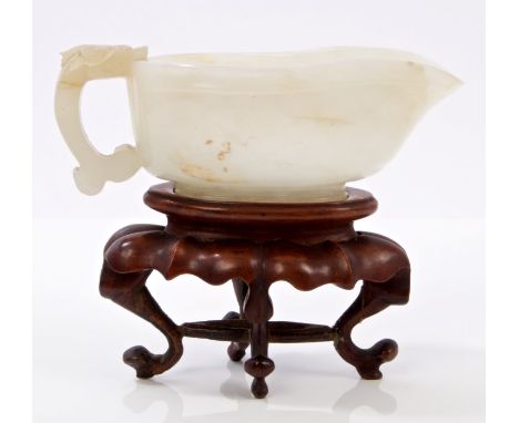Chinese pale jade libation cup, probably 19th century of tapering oviform shape, with carved chilong handle, 9cm long, raised