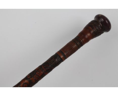 Early 20th century Japanese carved root stick, relief carved with allover continuous frieze of warriors within incised key bo