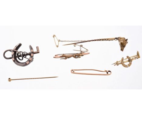 Victorian yellow metal stick pin with fox mask surmount and three Victorian hunting related brooches