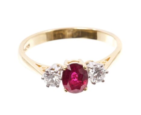 Ruby and diamond three stone ring with an oval mixed cut ruby estimated to weigh approximately 0.90 carats, flanked by a bril