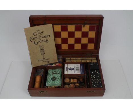 Edwardian mahogany games compendium, the fitted interior with pieces and boards, chess, draughts, back gammon, cribbage, stee