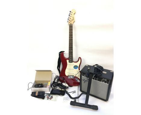 A guitaristâ€™s starter bundle comprising a Fender Squier electric guitar, Fender Frontman amplifier, headphones, stand and a