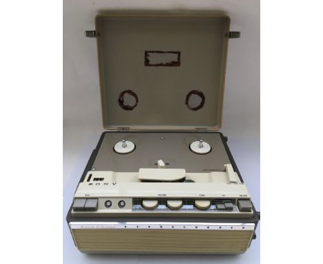 A Sony Sterecorder 464 reel to reel with service guide and a collection of reels.