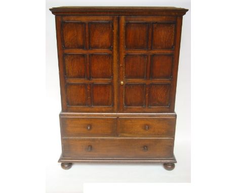 A Victorian oak linen press, the detachable projecting moulded cornice above a pair of six panel doors enclosing four sliding