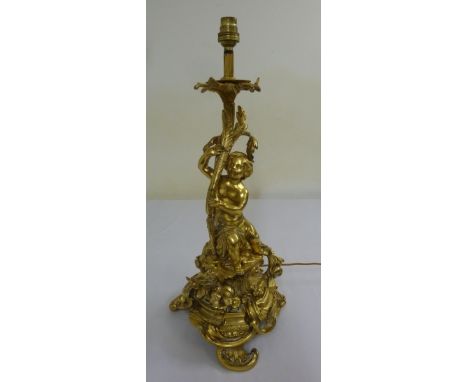 French gilt metal table lamp stand in the form of a figure on a shaped triform base