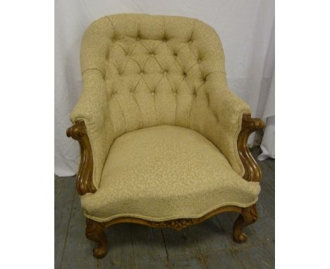 Victorian button back upholstered armchair on four scroll legs