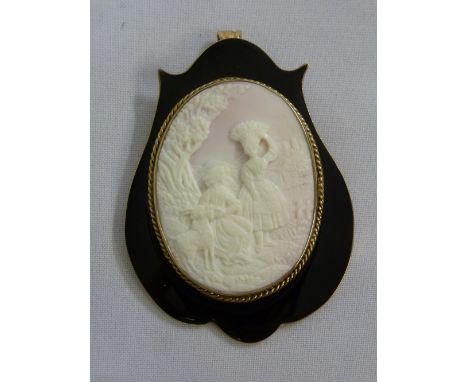 Cameo brooch set in black enamel and gold frame tested 9ct