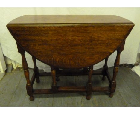 An oak gate leg drop flap table of customary form