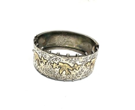 A 1950s silver Victorian revival bangle with gold detailing (33g)