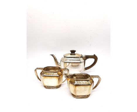 An Art Deco three piece silver tea set by Roberts &amp; Belk, consisting of a teapot, twin handled sugar bowl and milk jug. T