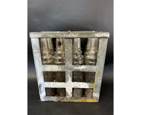 An eight-division oil crate containing seven Essolube and one Esso quart oil bottles. 