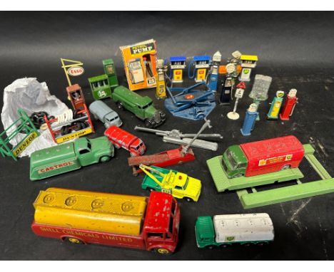 A selection of Dinky and other model vehicles and garage accessories etc. including petrol pumps, tyre stands etc. 