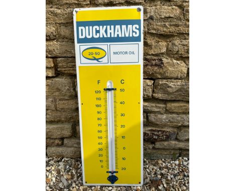A Duckhams 20-50 Motor Oil enamel garage wall thermometer, 13 x 36 1/4". 