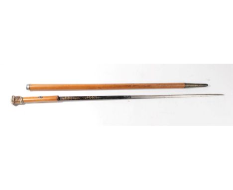 A 19th Century Malacca Swordstick, the 67.5cm single edge fullered steel blade half blued, engraved and gilt with scrolling f