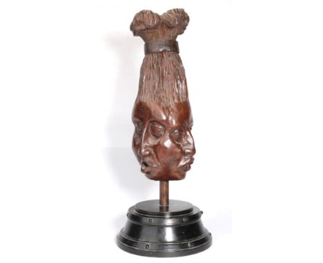 A Carved Oak Post Finial, carved as a tribal head with three different faces, the upswept coiffure later bound with a metal c