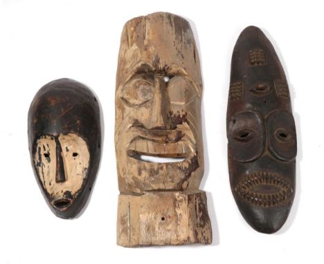 A Carved Wood Mask, possibly North American Indian, of light wood with remnants of gold paint, tall furrowed forehead, arched
