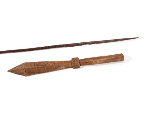 An Early 20th Century Samoan Sword Club, of honey coloured light wood, carved with bands of chevrons, the chamfered handle in