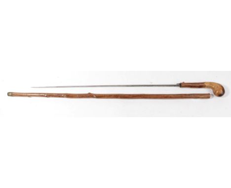 A Victorian Swordstick, the 53.5cm diamond section steel blade etched with scrolling foliage, the rustic haft, possibly black