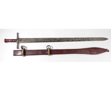 A 19th Century Sudanese Kaskara, the 88cm triple fullered double edge steel blade stamped with crescent moons, the steel cruc