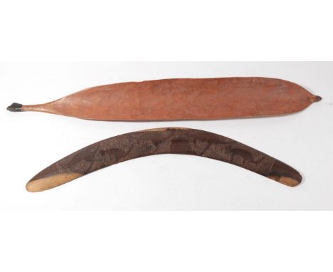 An Australian Aborigine Woomera, pre-1940, of curved light orange stained wood, one side with scratched chevron decoration, t