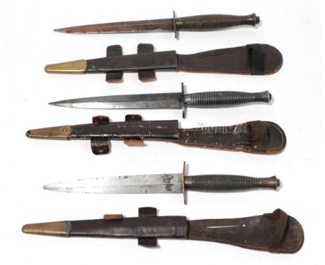 A Third Pattern Commando Knife by Wilkinson Sword, the machine forged blued steel blade etched with maker's name, with ribbed