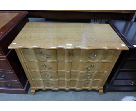 A French oak four drawer commode 
