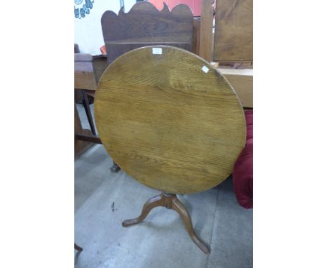 A George III oak circular tilt top tripod tea table 
