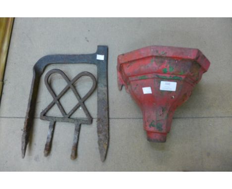 A cast iron drain hopper and two wrought iron boot scrapers 