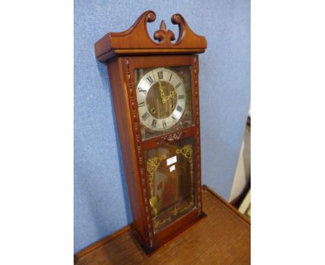 A mahogany wall clock and a box of assorted vintage items 