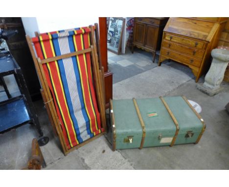 An early 20th Century steamer trunk and two deck chairs 