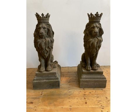 A PAIR OF ORNAMENTAL GARDEN LION FIGURES, two matching weathered cast concrete figures depicting lions wearing crowns, on pli
