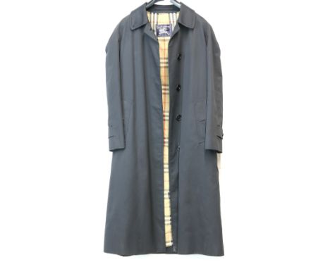 Classic Burberrys to include trench coat, a black Macintosh and matching hat and a zip up jacket (4).       Black mac 8 petit