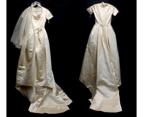 A Normal Hartnell cream satin wedding dress with train, lined and with part net underskirt,  believed to date to 1965, with o