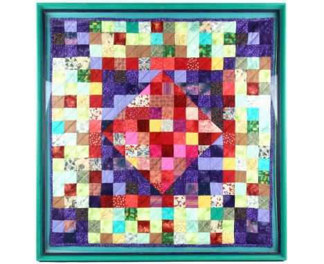 A vintage patchwork quilt, Framed and glazed 88cm x 86cm.       