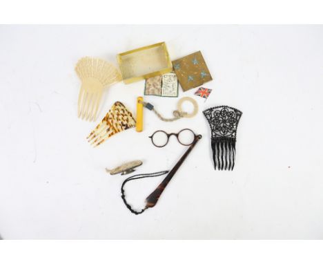 Hair accessories to include three hair combs, a pair of lorgnettes in faux tortoiseshell,  a Manhattan compact, a silver nail