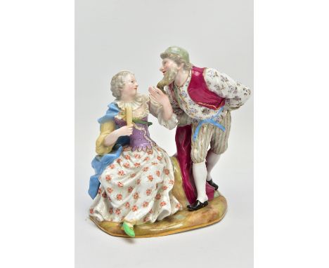 A LATE 19TH CENTURY MEISSEN FIGURE GROUP OF PANTALONE AND COLUMBINE, modelled as seated and standing on a grassy mound, incis