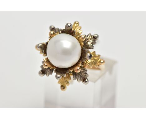 A WHITE AND YELLOW METAL CULTURED PEARL RING, of foliate design, set with a principal part drilled white cultured bouton pear