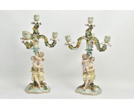 A PAIR OF LATE 19TH / EARLY 20TH CENTURY PLAUE PORCELAIN FLORALLY ENCRUSTED FIGURAL CANDELABRA, each with four light upper se