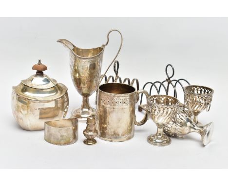 A PARCEL OF 19TH AND 20TH CENTURY SILVER, comprising an 19th century helmet shaped pedestal cream jug, bright cut decoration,