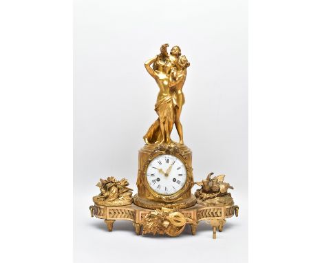 A LATE 19TH CENTURY FRENCH GILT BRASS FIGURAL MANTEL CLOCK BY JACQUIER, surmounted by the three Graces holding aloft a cherub