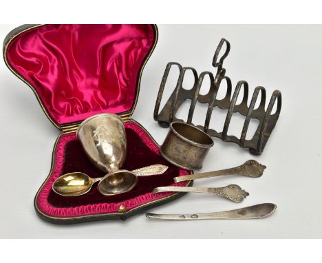 A SMALL PARCEL OF SILVER, comprising a late Victorian seven bar toast rack of arched form, on four bun feet, maker James Dixo