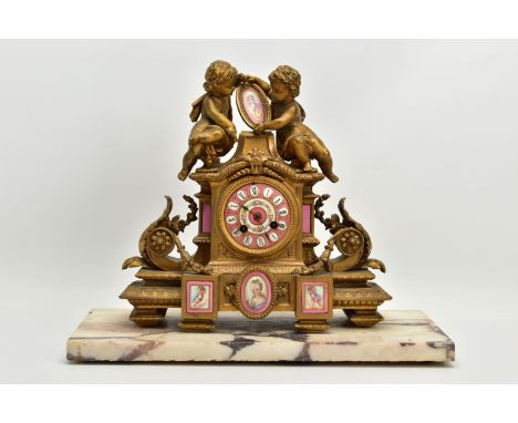 A MID 19TH CENTURY FRENCH GILT METAL AND PORCELAIN MOUNTED FIGURAL MANTEL CLOCK, the case surmounted with two putti, one of w