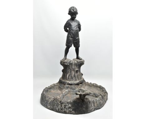 AN EARLY 20TH CENTURY HOLLOW CAST LEAD FIGURAL BIRD BATH, modelled as a boy standing on a tree trunk with his hands behind hi