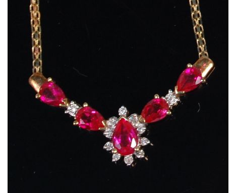 A modern 10ct gold pink sapphire and diamond set necklet, the centre pear cut sapphire in a surround of small brilliants, fla